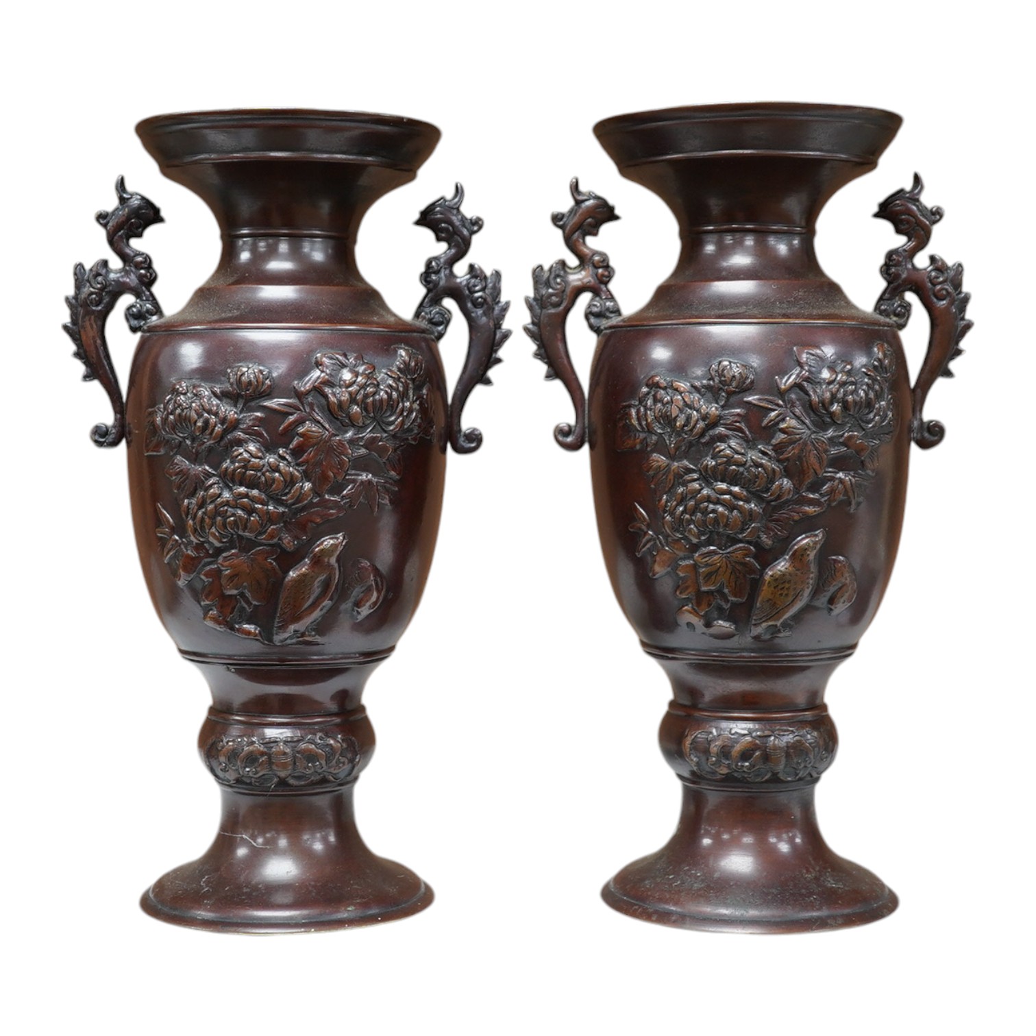 A pair of Japanese two handled bronze vases decorated in relief with birds and flowers, 26cm high. Condition - good